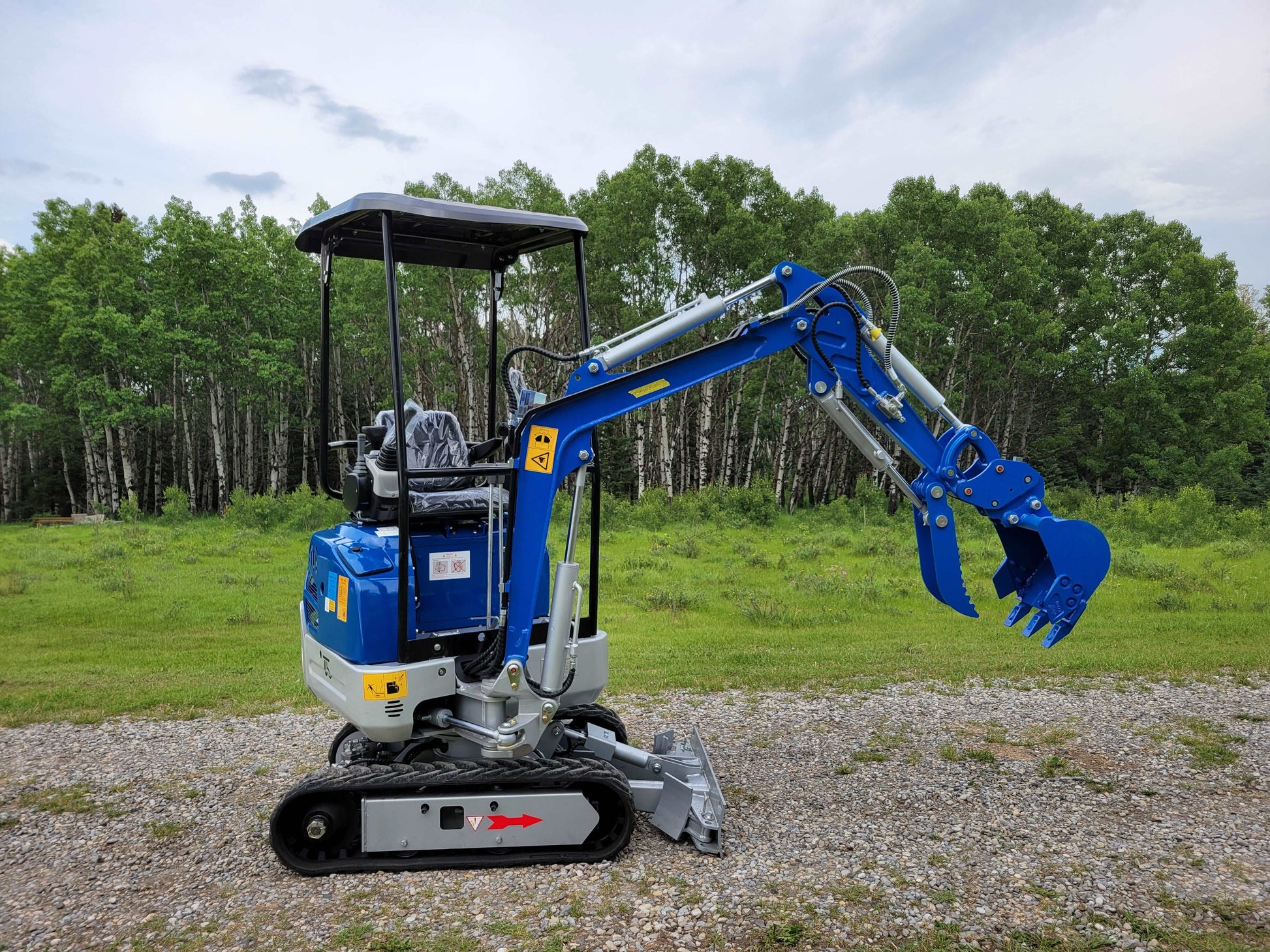 JoyT5 1.2-ton mini excavator for rent in Calgary, Alberta. Side profile of compact excavator JT5120 designed for landscaping, digging, and small construction projects in Canada.