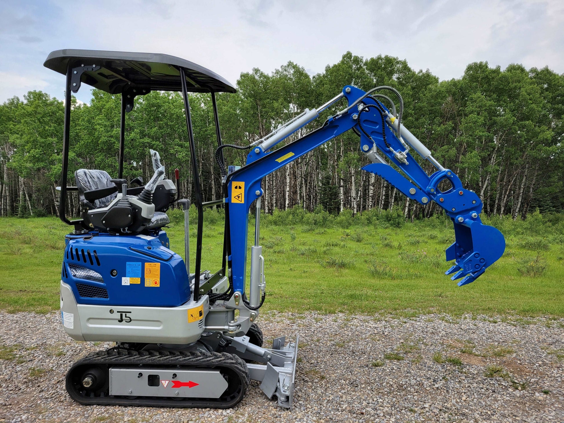 Side view of JoyT5 1.2 ton mini excavator for rent in Calgary, Alberta compact excavator JT5120 ideal for landscaping, digging, and small construction projects in Canada.