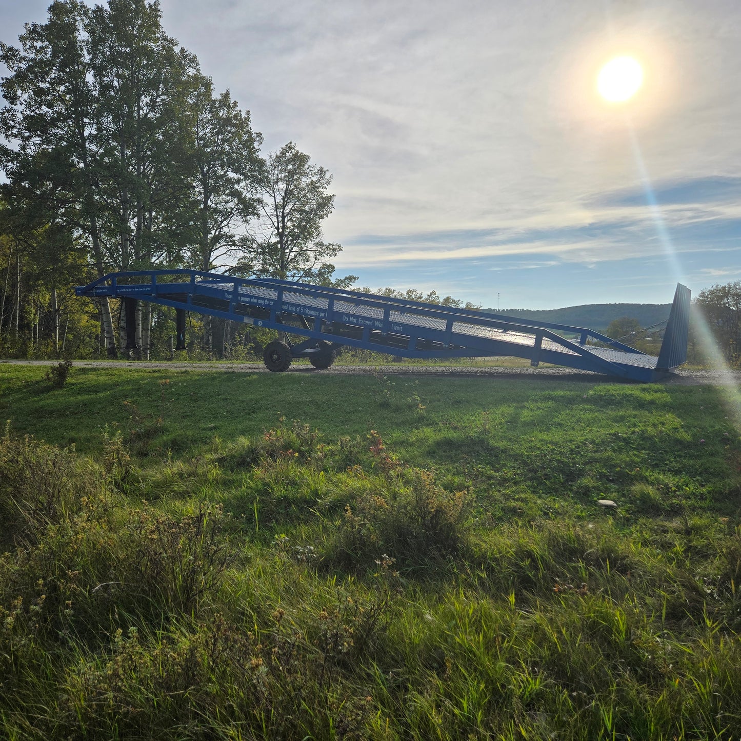 12 ton mobile loading ramp for sale in Canada, JoyT5 heavy-duty portable yard ramp shown outdoors in sunset lighting for forklifts and trucks.