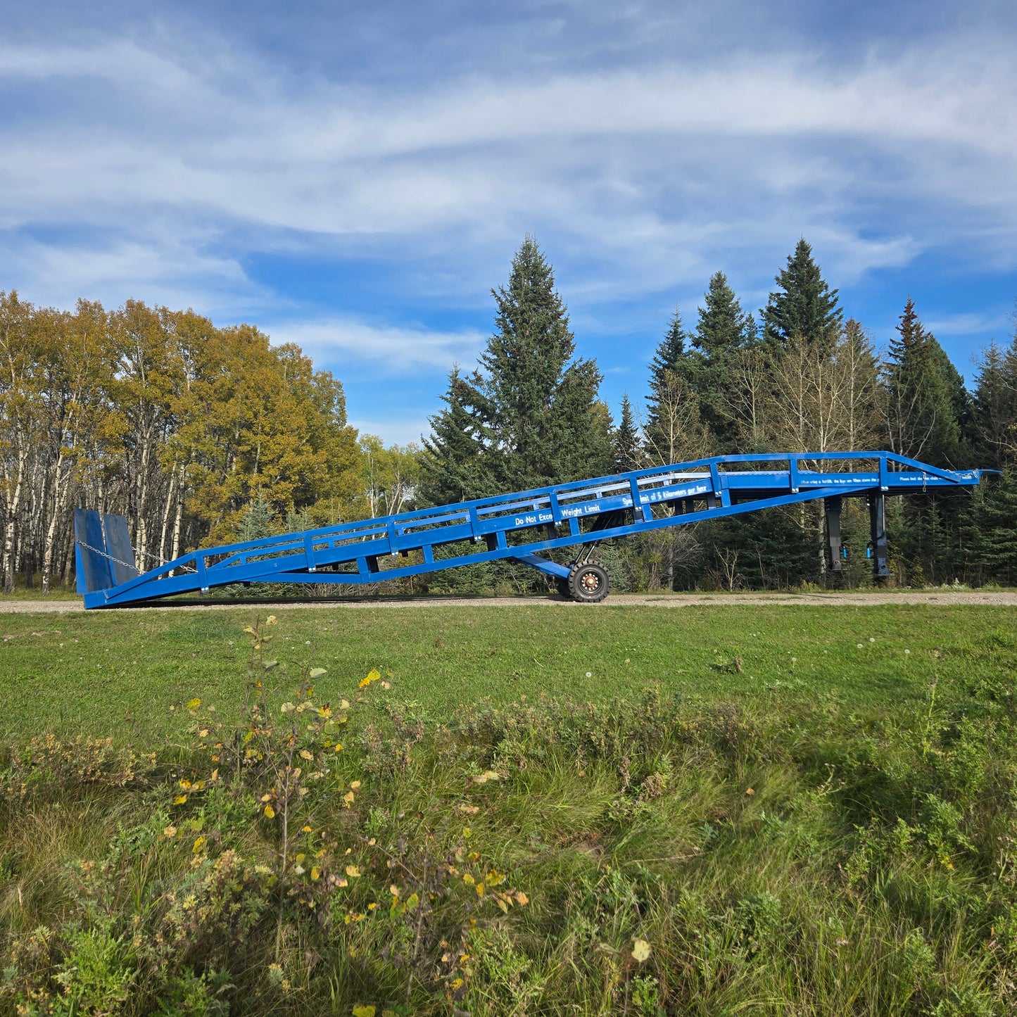 12 ton mobile loading ramp for sale in Canada, JoyT5 heavy-duty steel ramp for forklifts and trucks, full side view in outdoor setting.