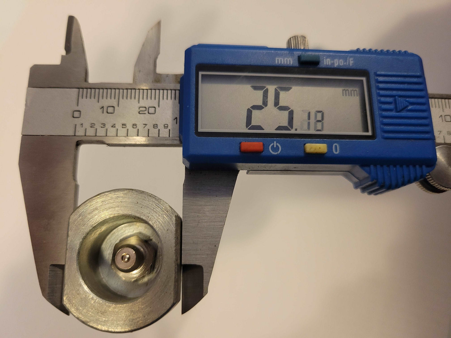 digital caliper showing 25 millimeter diameter of metal excavator bucket pin for Agrotk and FF Industrial mini excavator replacement parts in Canada