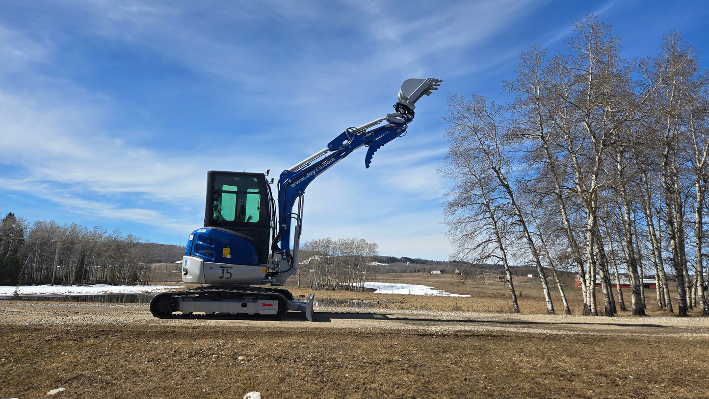 JT5350 3.5 ton mini excavator with Kubota engine lifting bucket during field test in open field Canada compact excavator for landscaping and construction use
