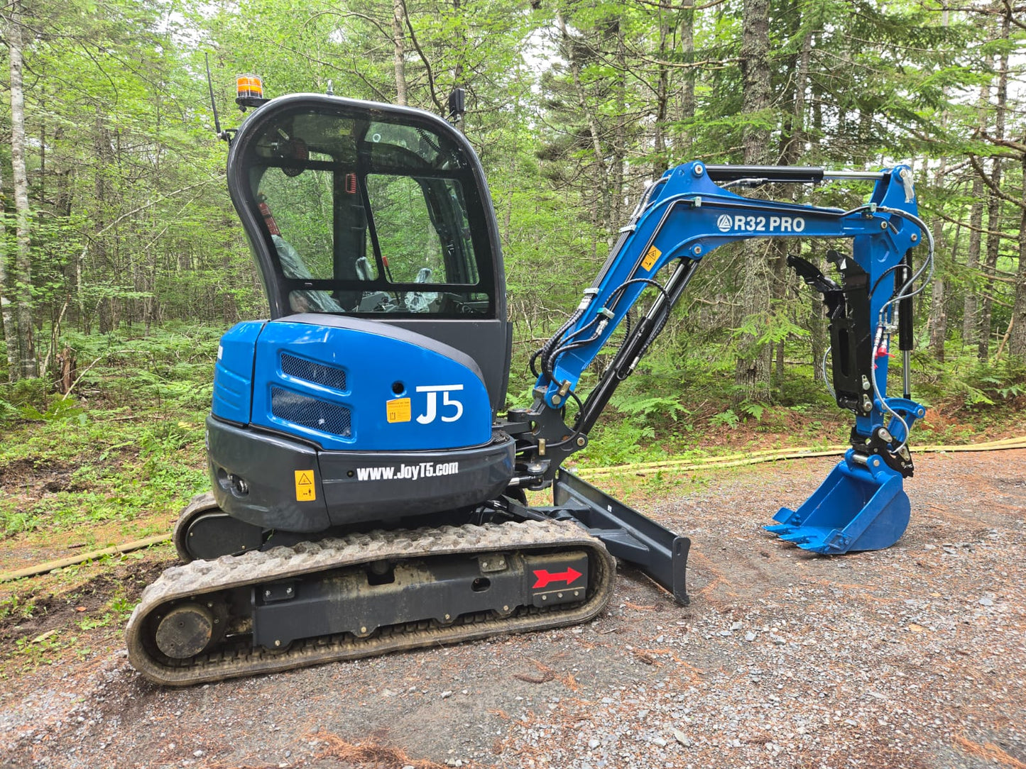 Rippa R32 Mini Excavator with hydraulic system parked in Canada forest, compact excavator for landscaping and construction