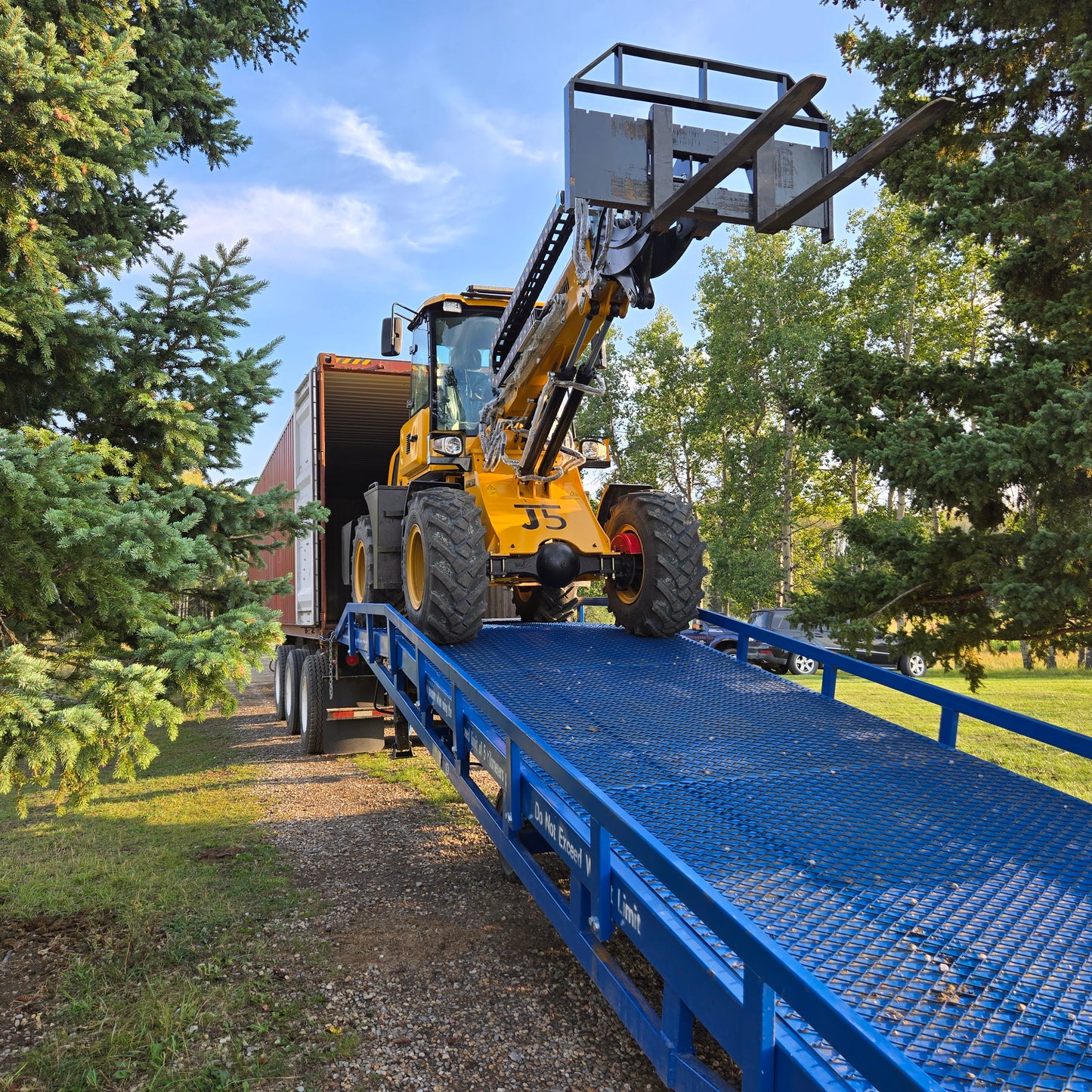 JoyT5 12 ton mobile loading ramp in Canada used for forklift or wheel loader to load heavy equipment into a shipping container truck.