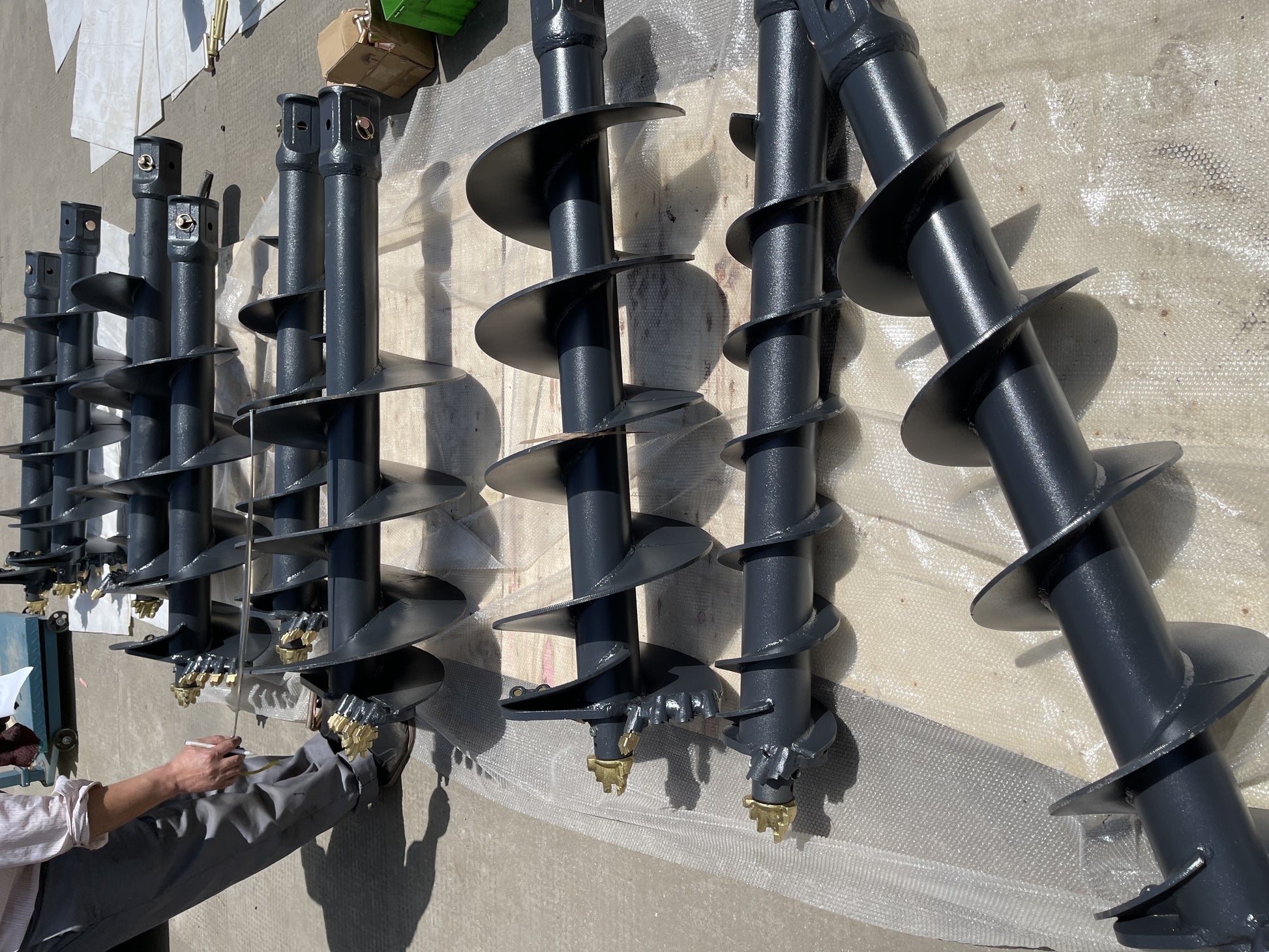 Multiple JoyT5 hydraulic auger drill bits for excavators – heavy‑duty earth drilling attachments designed for foundation, construction, and digging projects across Canada.