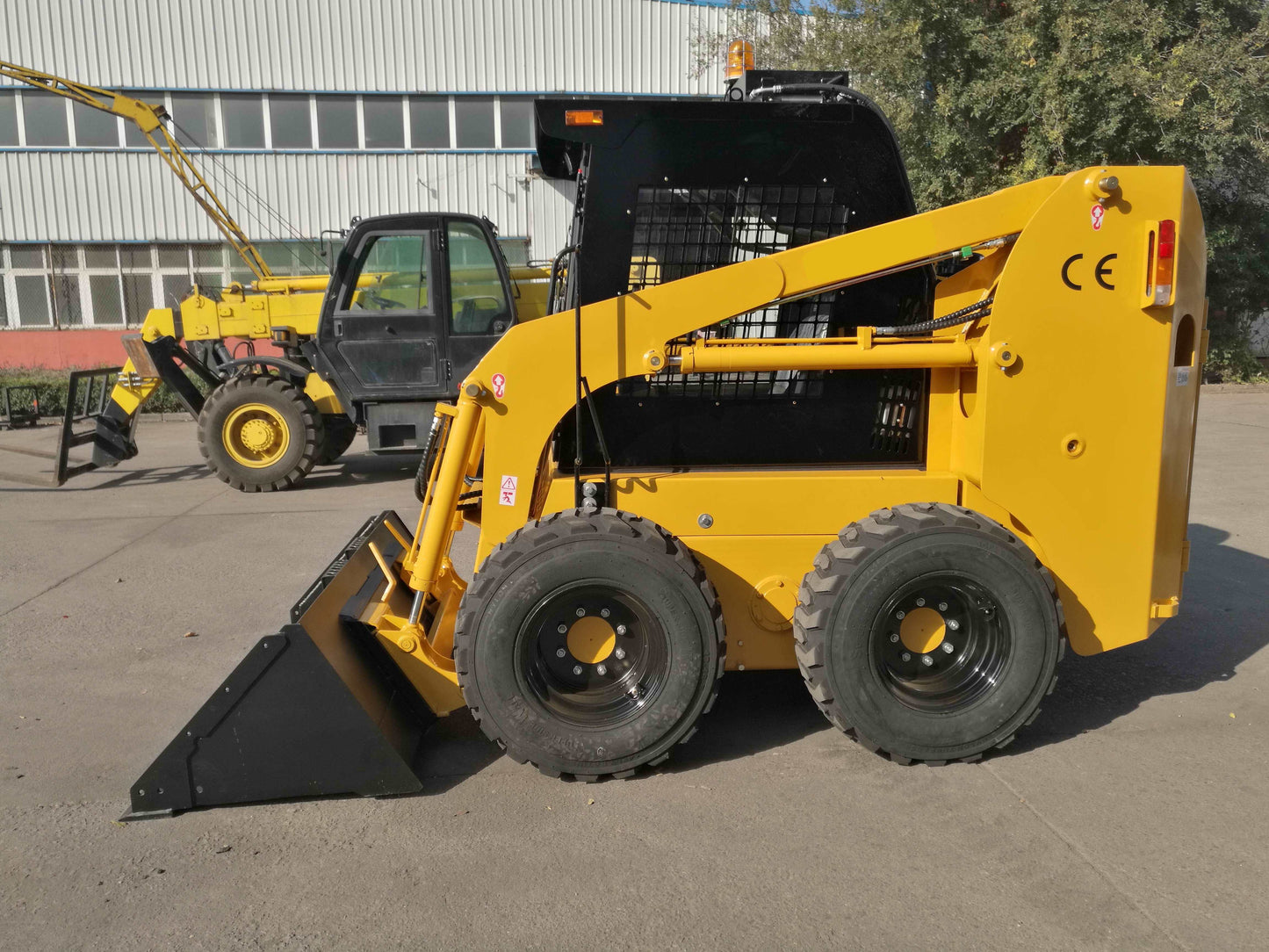 JoyT5 JT5SSW75 wheeled skid steer side profile showing bucket attachment 73 HP engine strong tires and enclosed cab designed for construction farming and material handling work across Canada