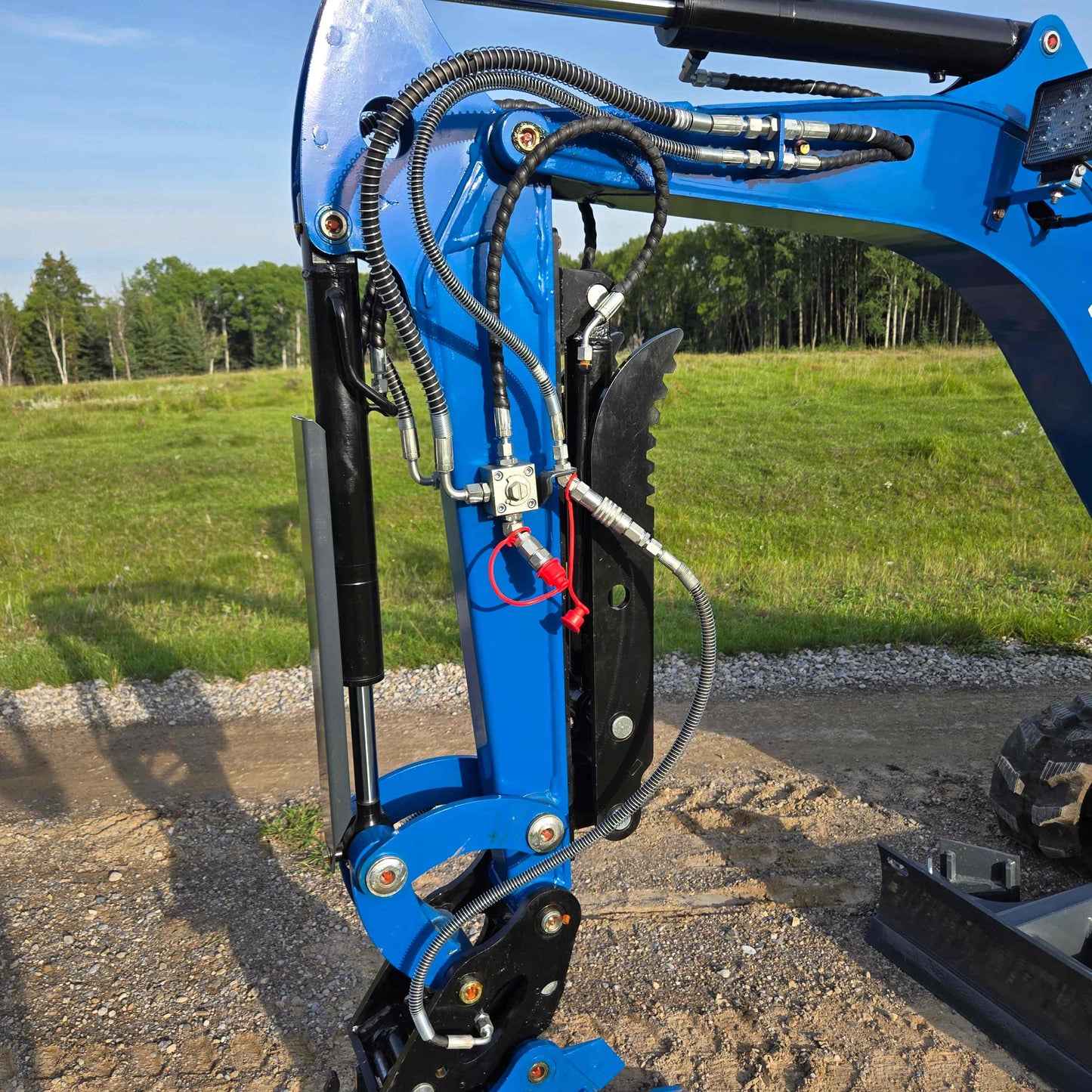 Close-up view of JoyT5 Rippa R18 Mini Excavator hydraulic arm system with hoses, joints, and cylinder