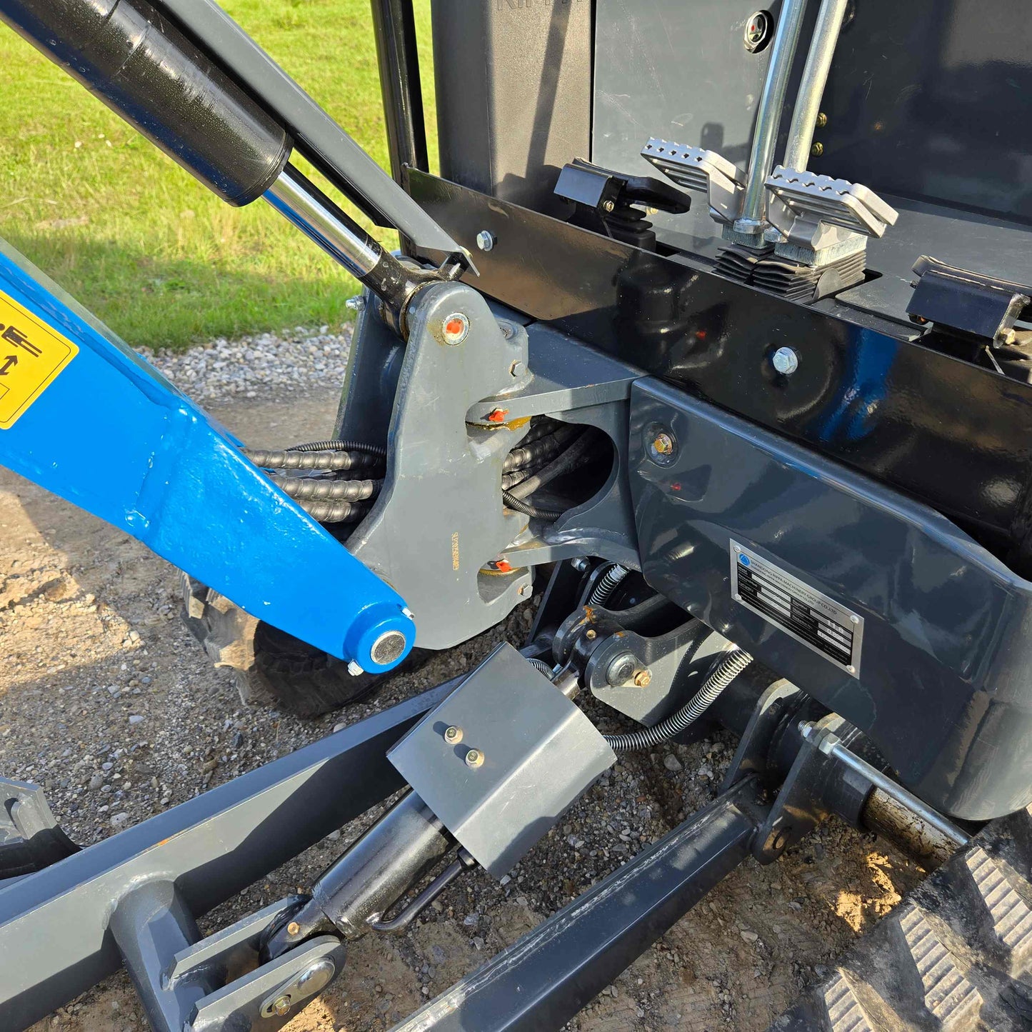 Close-up view of JoyT5 Rippa R18 Mini Excavator hydraulic boom base with pivot joint and cylinder connection