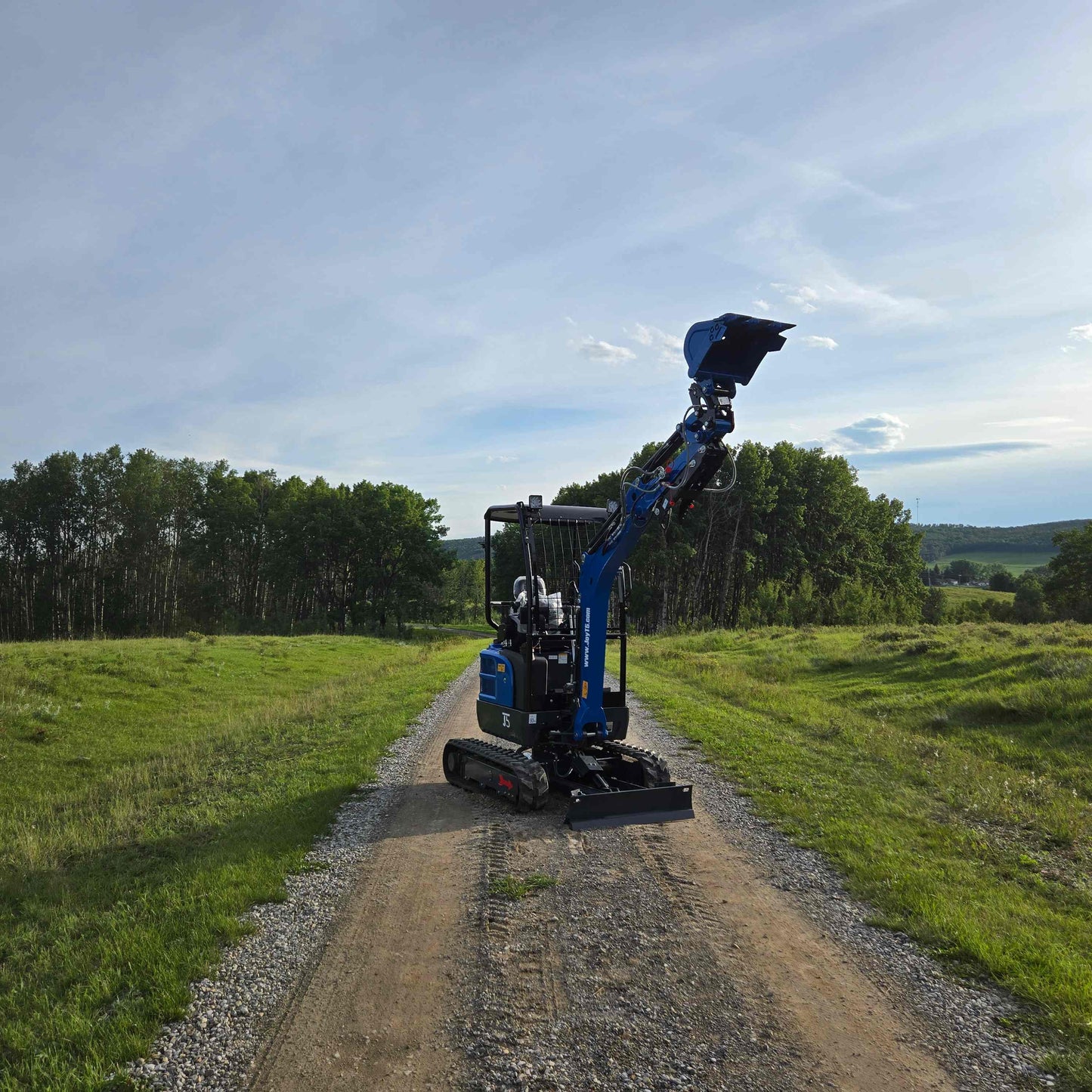 JoyT5 Rippa R18 Mini Excavator on gravel road with raised bucket outdoor working view