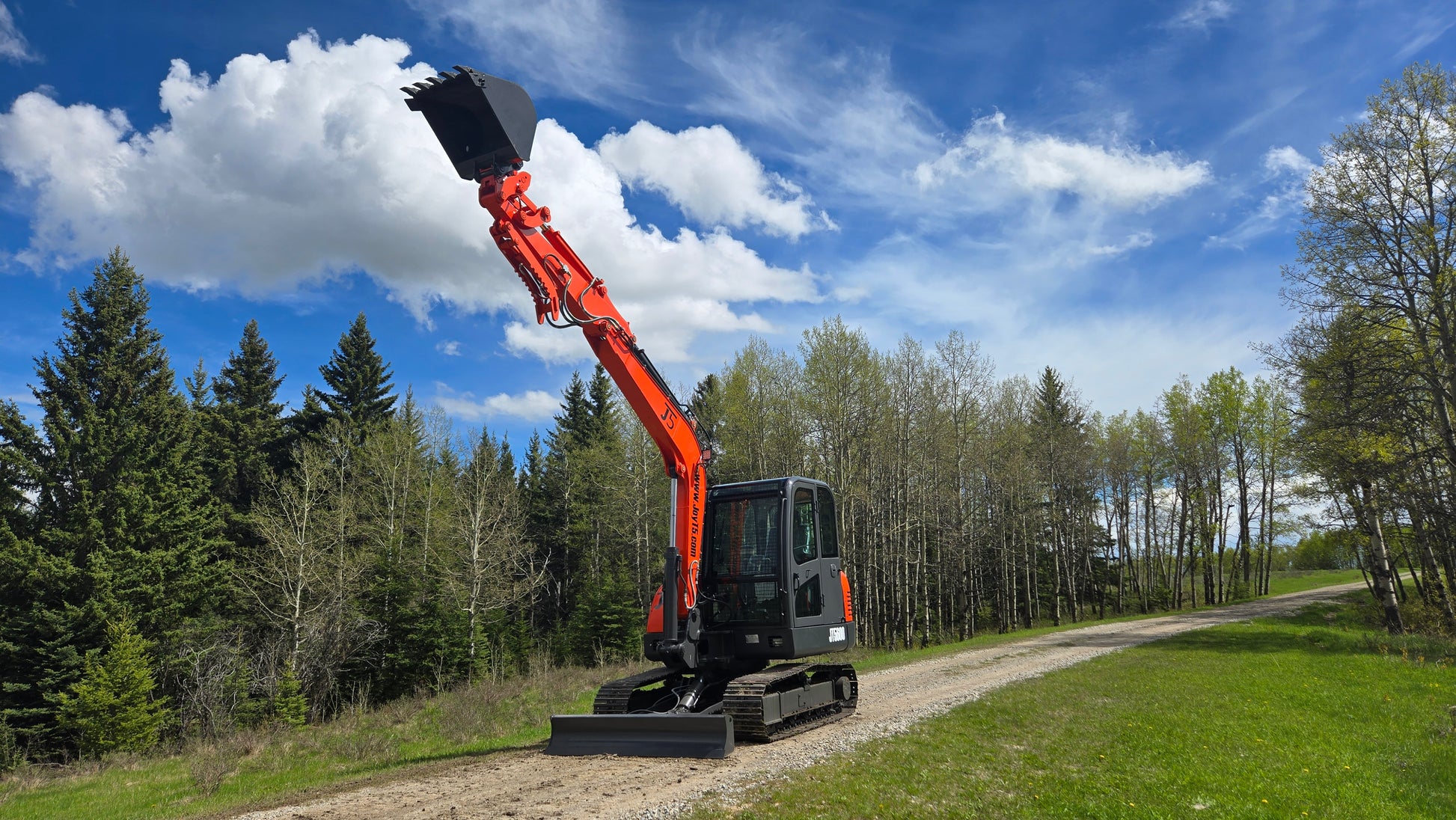 JT5600 6 Ton JoyT5 excavator with Yanmar engine, high reach boom and digging bucket lifted upwards on construction site