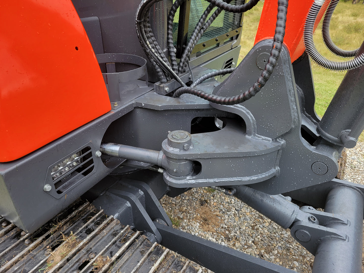 Close-up view of JT5600 6 Ton Mini Excavator boom hydraulic cylinder and hoses for powerful digging performance