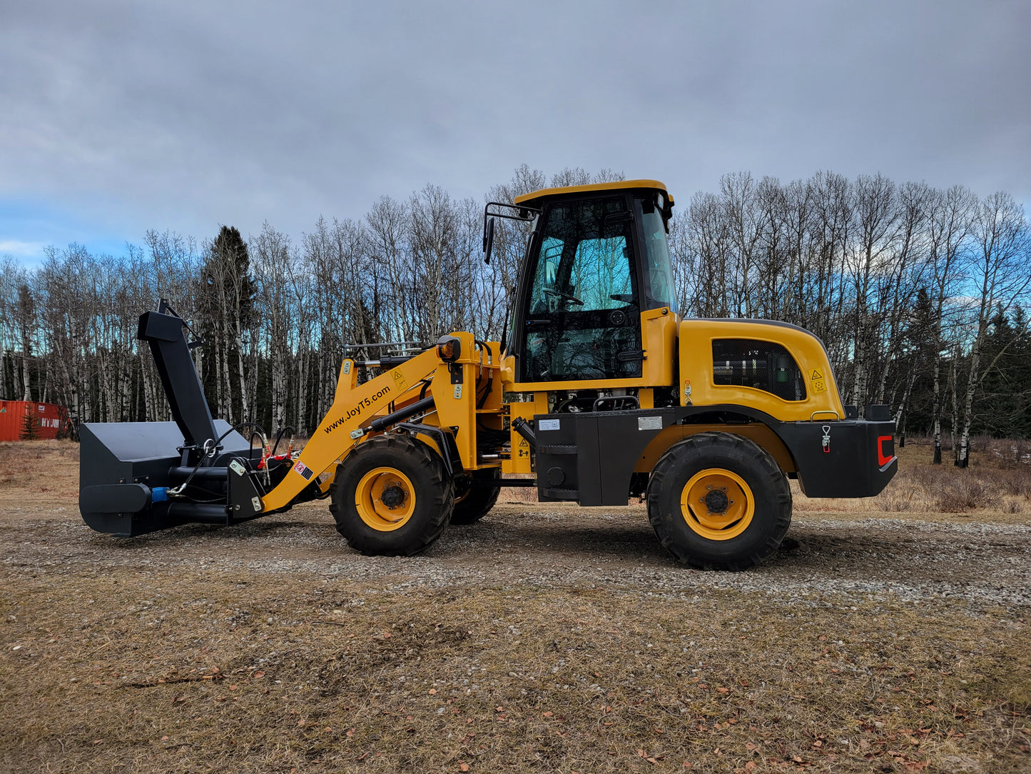 JT5WL1200 compact wheel loader with snow blower attachment side profile, 1.2 ton 2650 lbs mini loader for snow removal and outdoor construction work.