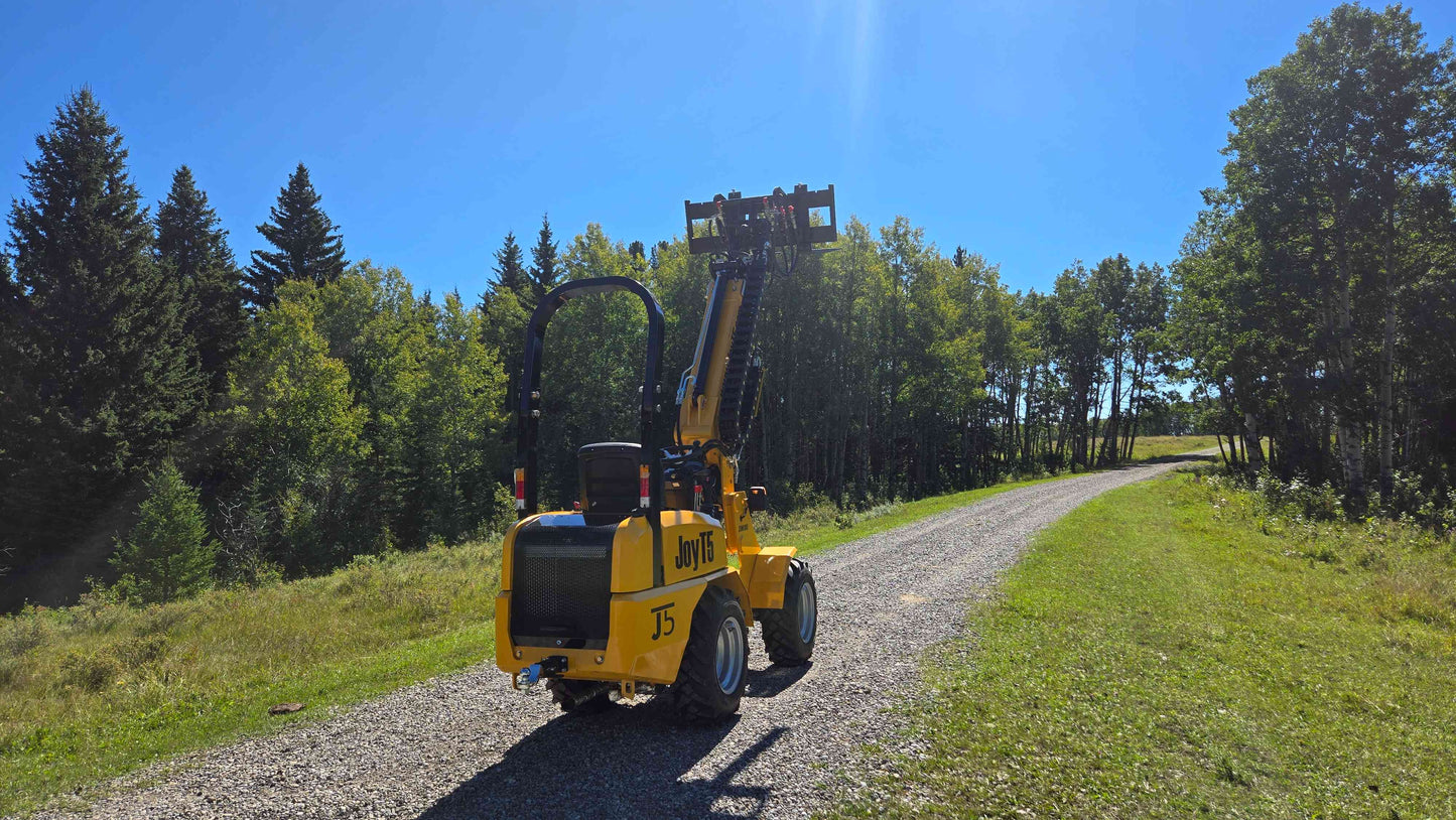 JT5WL800 compact mini wheel loader 800kg 1750 lbs rear view with raised boom and pallet fork attachment