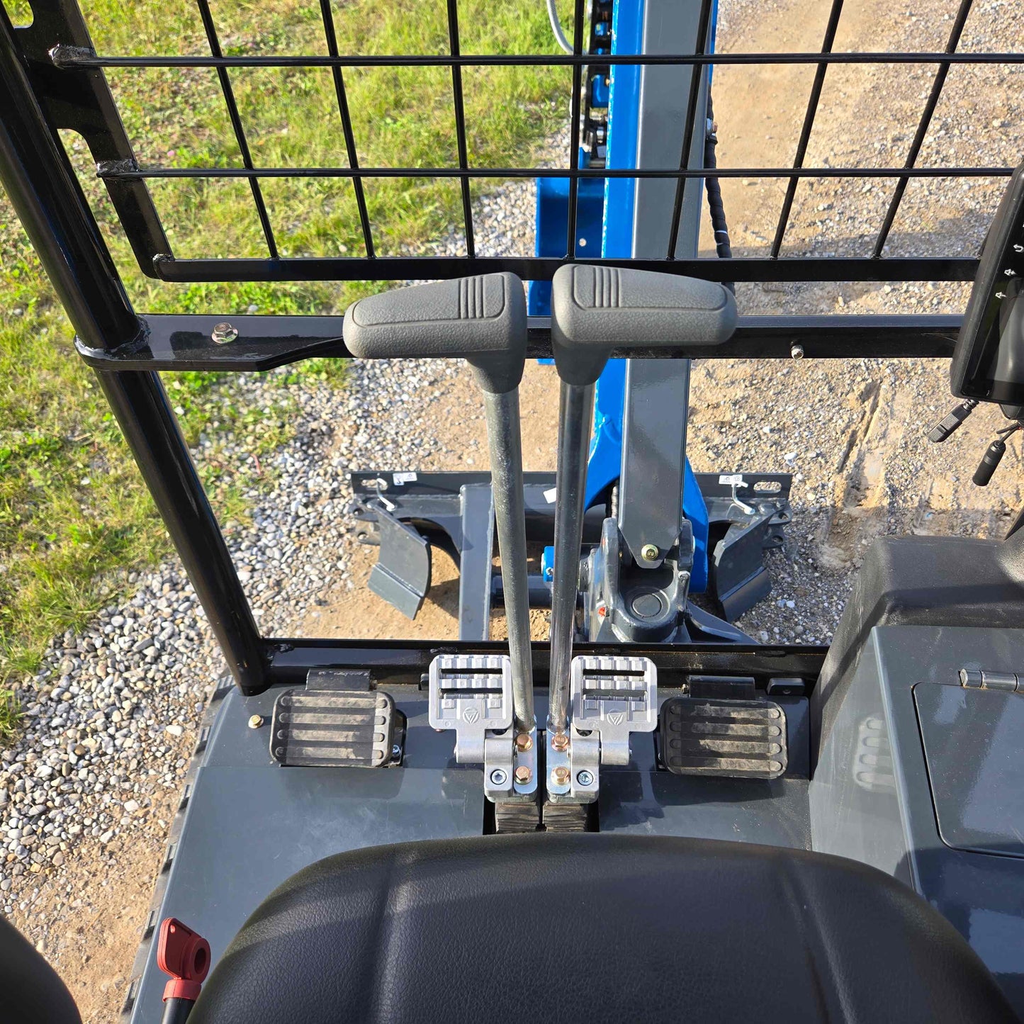 JoyT5 Rippa R18 Mini Excavator operator controls with levers and foot pedals inside the cabin