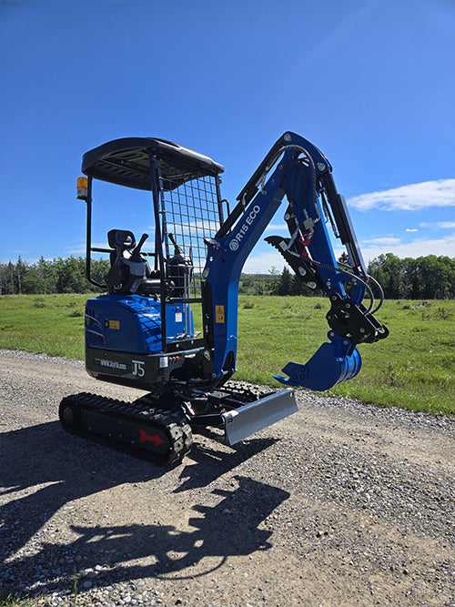 Rippa R15 Mini excavator for sale R15 with front blade and lowered boom on gravel road in open field