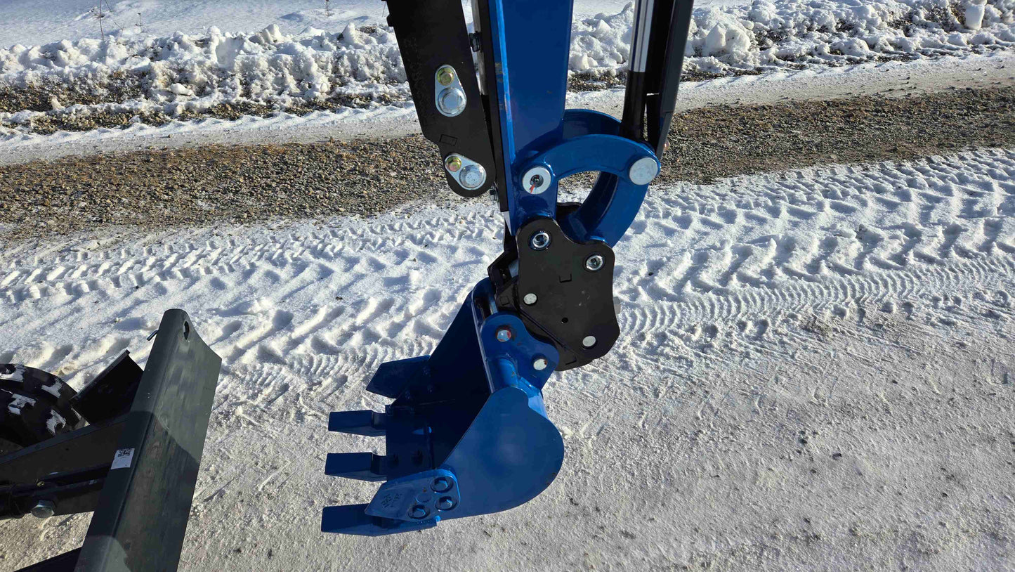 Close-up view of Rippa R10 Mini Excavator bucket and hydraulic arm on snowy road