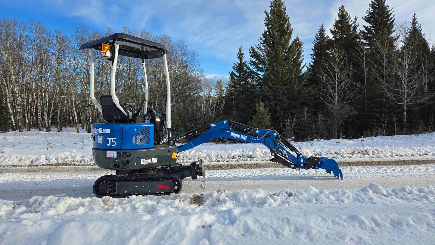 Rippa R10 Mini Excavator standing on snow with digging arm extended close to ground