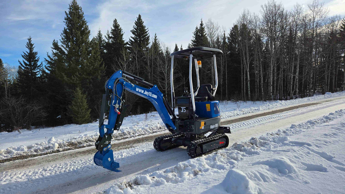 Rippa R10 Mini Excavator parked on a snowy forest road in winter