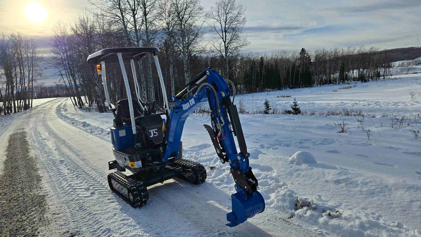 Rippa R10 Mini Excavator working on a snowy road in winter landscape