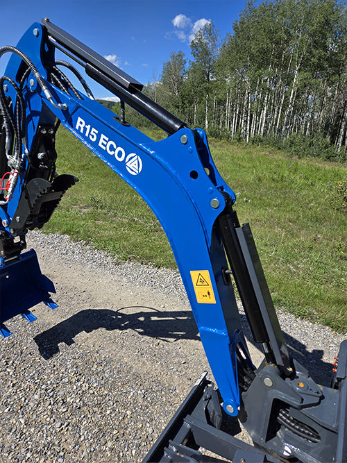 Close up of Rippa R15 mini excavator for sale arm and hydraulic system on gravel road