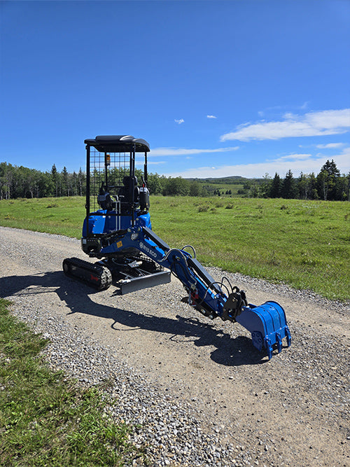 Rippa R15 mini excavator with digging arm extended on gravel road in field