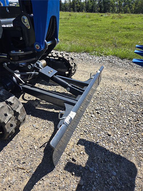 Closeup of Rippa R15 mini excavator dozer blade on gravel ground