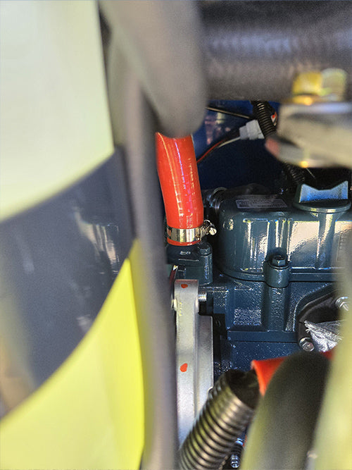 Close-up view of Rippa R15 mini excavator for sale engine with red hose and mechanical components