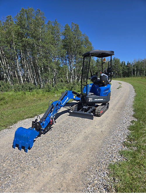 Rippa R15 mini excavator for sale with digging arm extended on gravel road in outdoor site