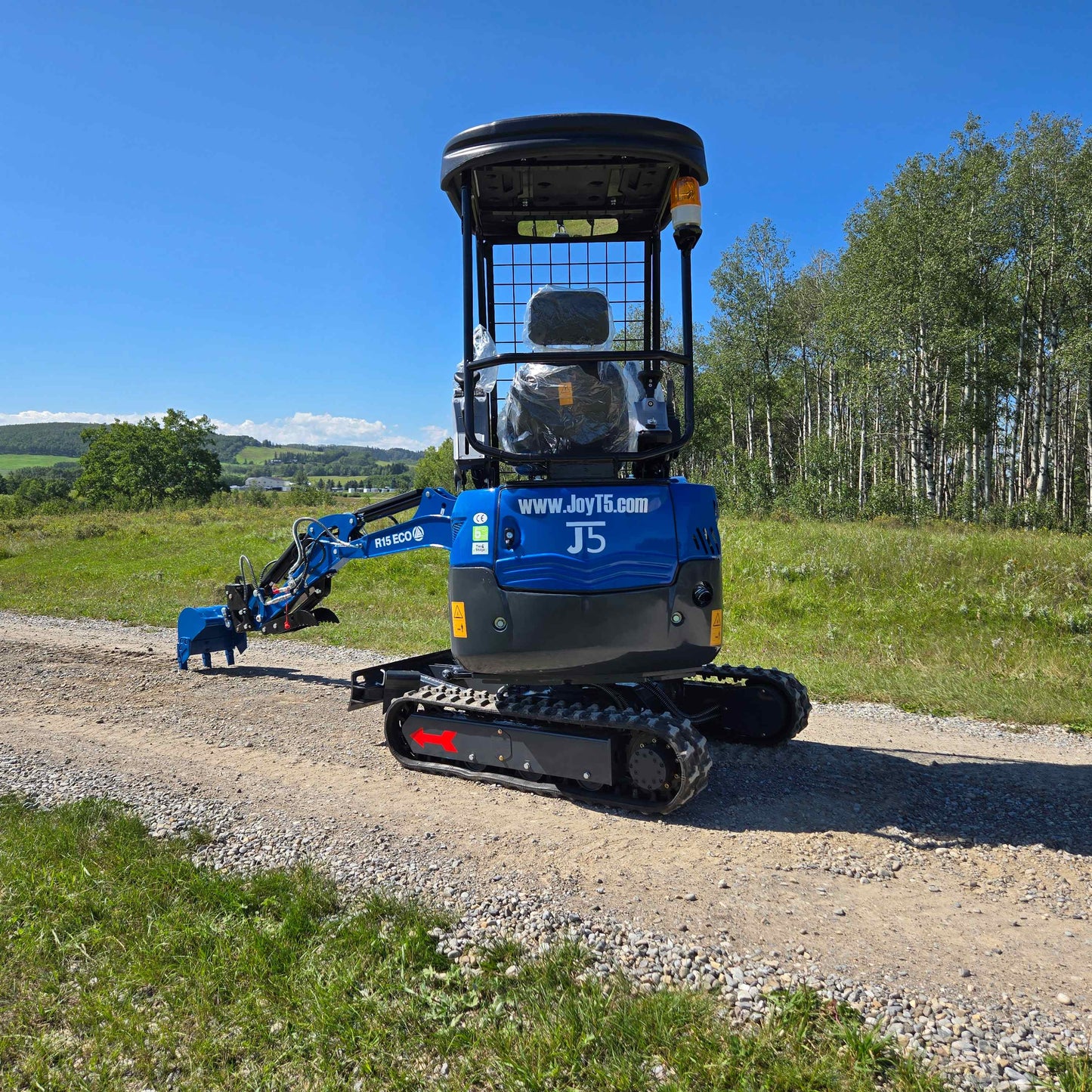 Rippa R15 Mini Excavator For Sale – rear view of compact digger with extended arm on gravel path.