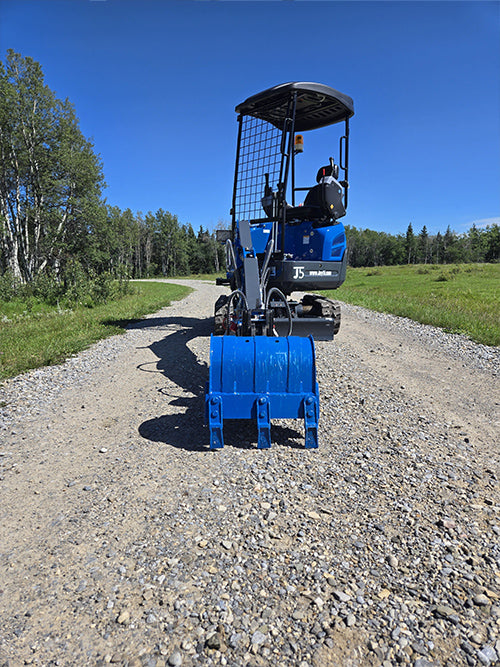 Front view of Rippa R15 mini excavator with digging bucket on gravel road