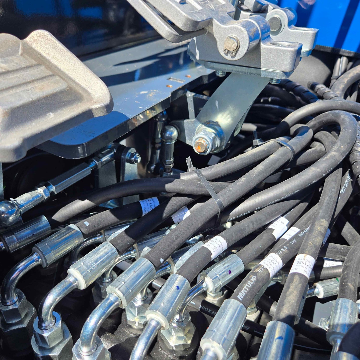 Close-up view of hydraulic hoses and connections on the Rippa R15 Mini Excavator, highlighting durable build quality.
