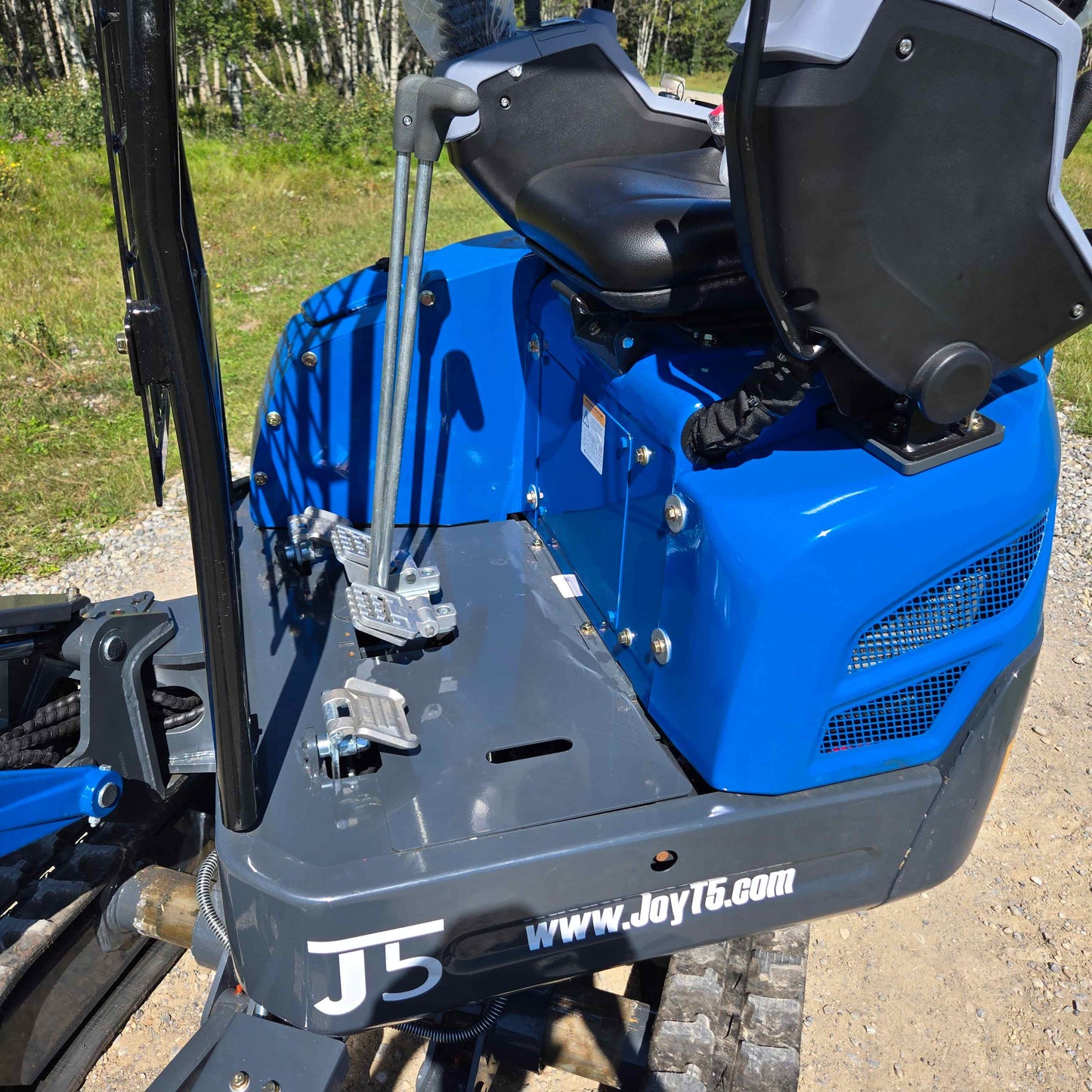 Rippa R15 Mini Excavator operator seat with dual control levers and foot pedals, designed for easy operation.