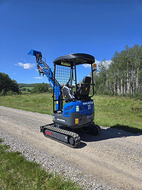 Rippa R15 mini excavator side view on gravel road with raised digging arm
