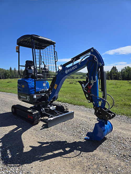 Compact rippa r15 mini excavator for sale with front blade and digging bucket on gravel road in countryside