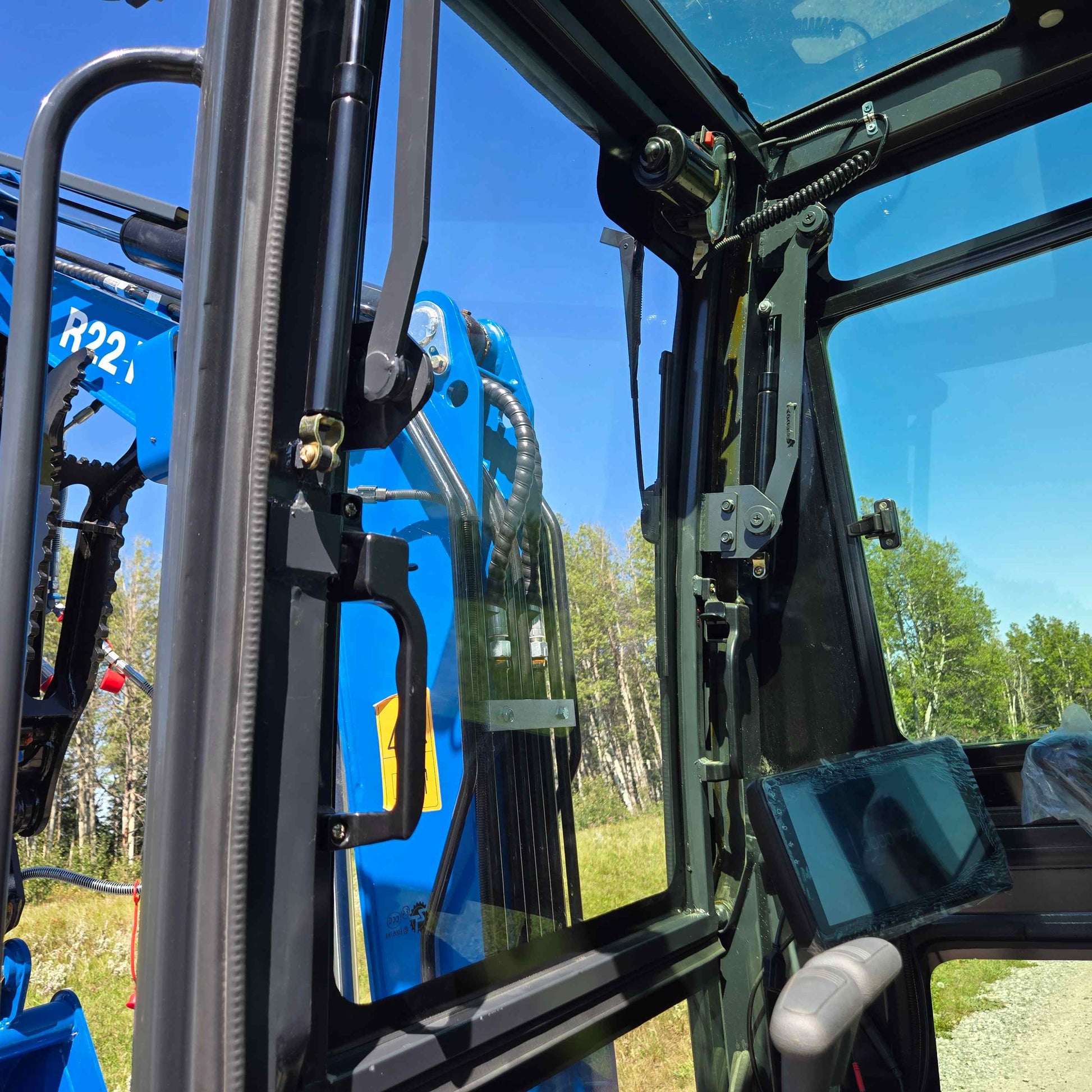 Operator view from inside Rippa R22 mini excavator cabin – 2 ton compact excavator for sale in Canada with Yanmar engine, clear visibility and digital monitor control system.