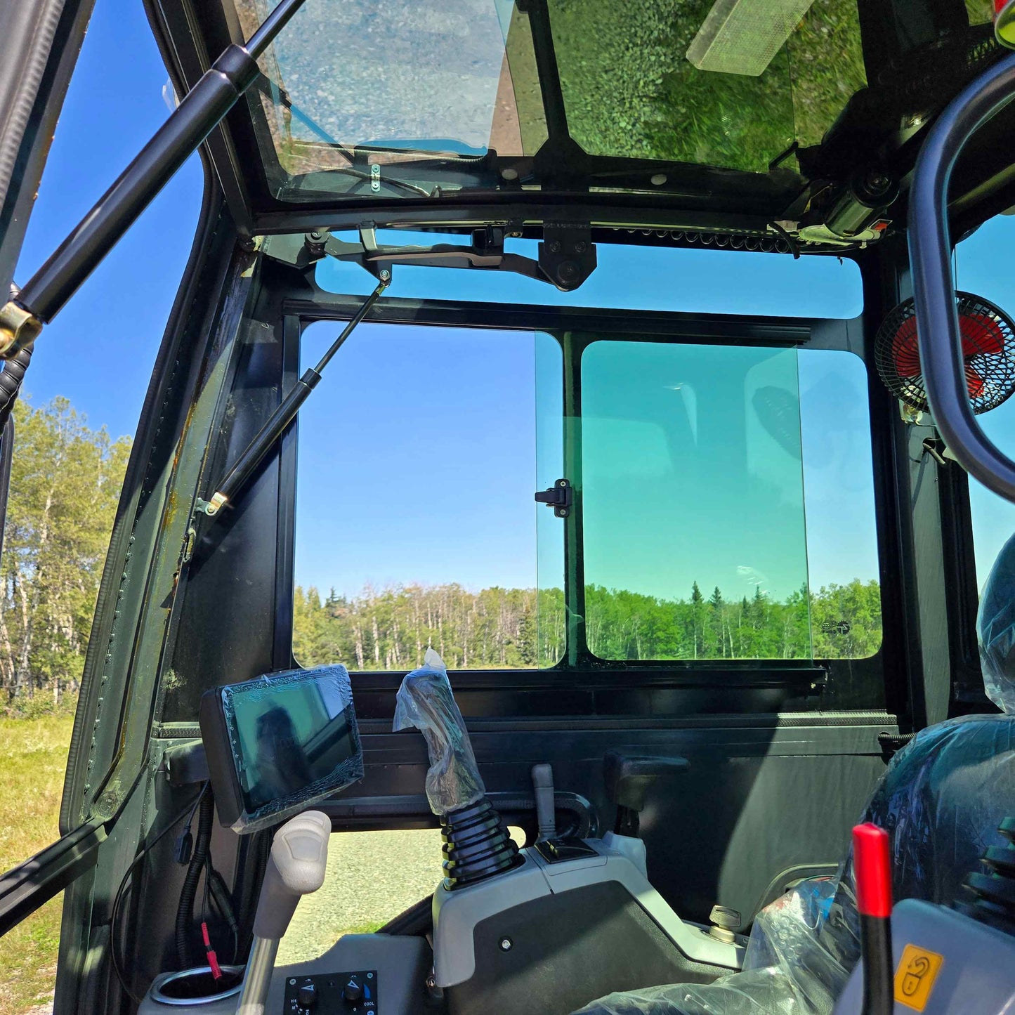 Rippa R22 Mini Excavator for sale cabin interior showing joystick controls, monitor screen, glass roof, and rear sliding window.