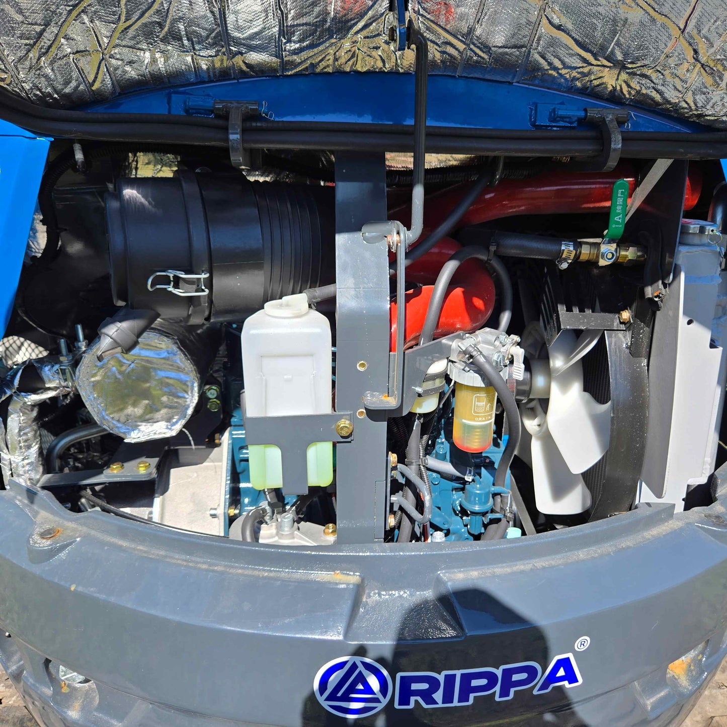 Close-up view of Rippa R22 mini excavator for sale engine compartment showing radiator, coolant tank, air filter, and hydraulic components.