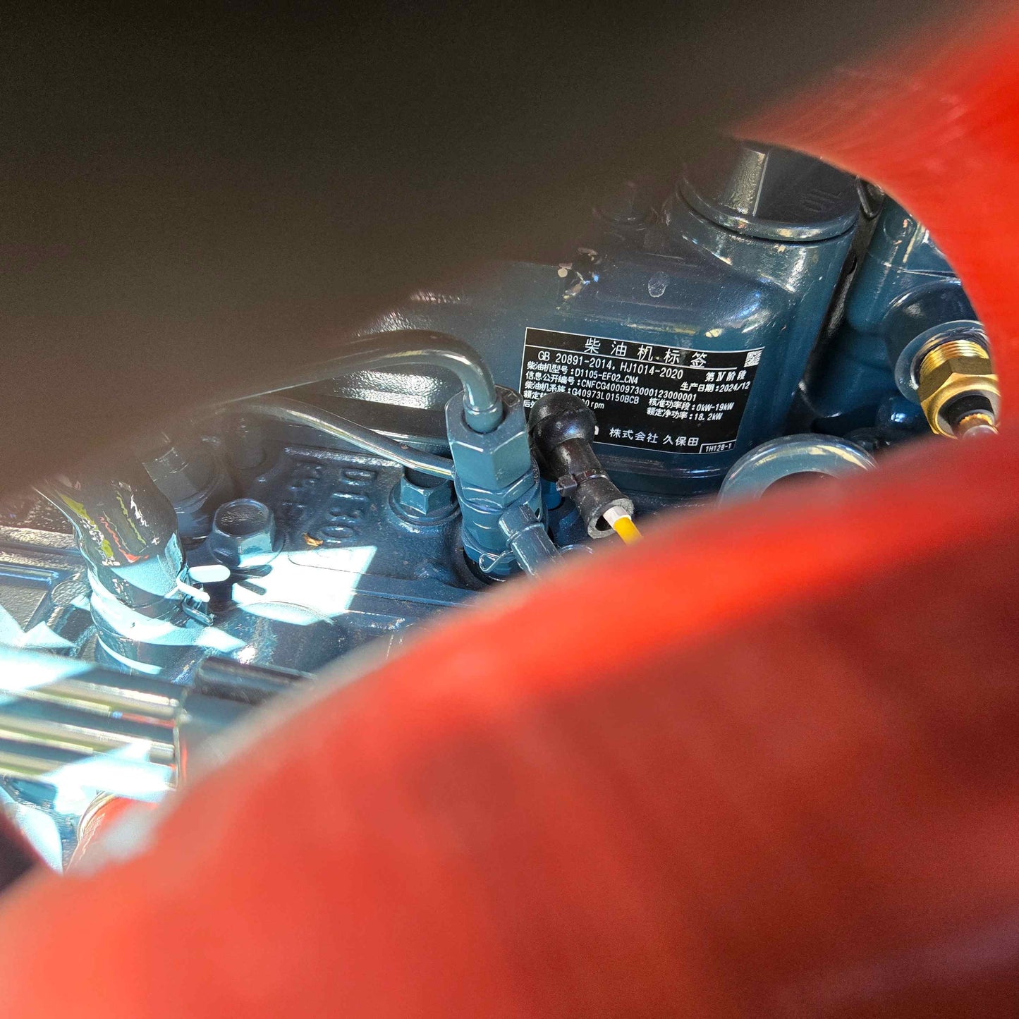 Close-up of Rippa R22 mini excavator for sale engine with manufacturer label in Chinese, partially visible behind engine components.