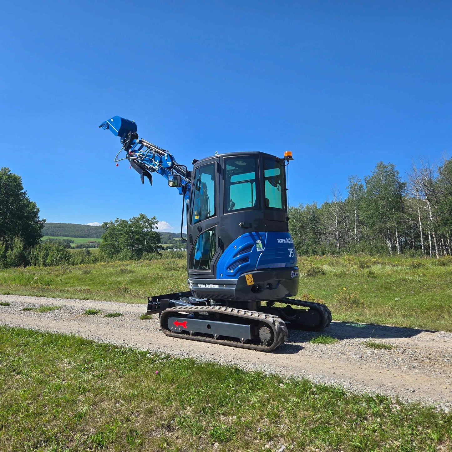 Rippa R22 Mini Excavator for sale rear side view with lifted bucket on gravel road.