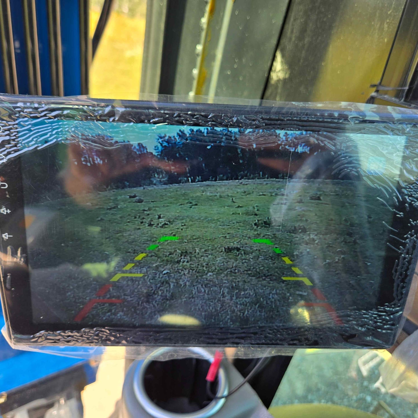 Rear-view camera display of the Rippa R22 Mini Excavator for sale showing a clear ground view with guiding lines in red, yellow, and green for safe reversing.