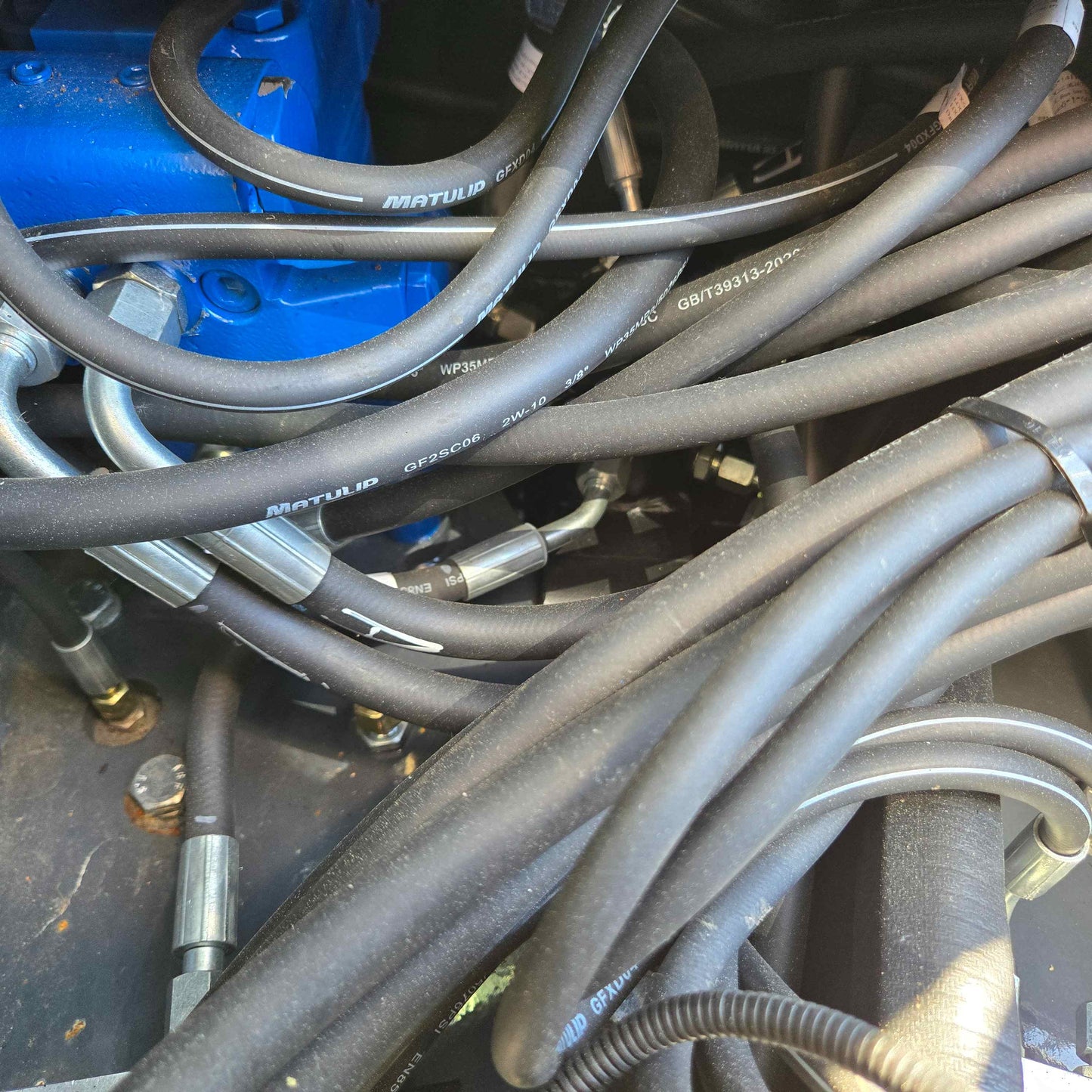 Close-up view of hydraulic hoses in Rippa R22 mini excavator – compact 2 ton excavator for sale in Canada with Yanmar engine, showing durable high-pressure fluid line system.