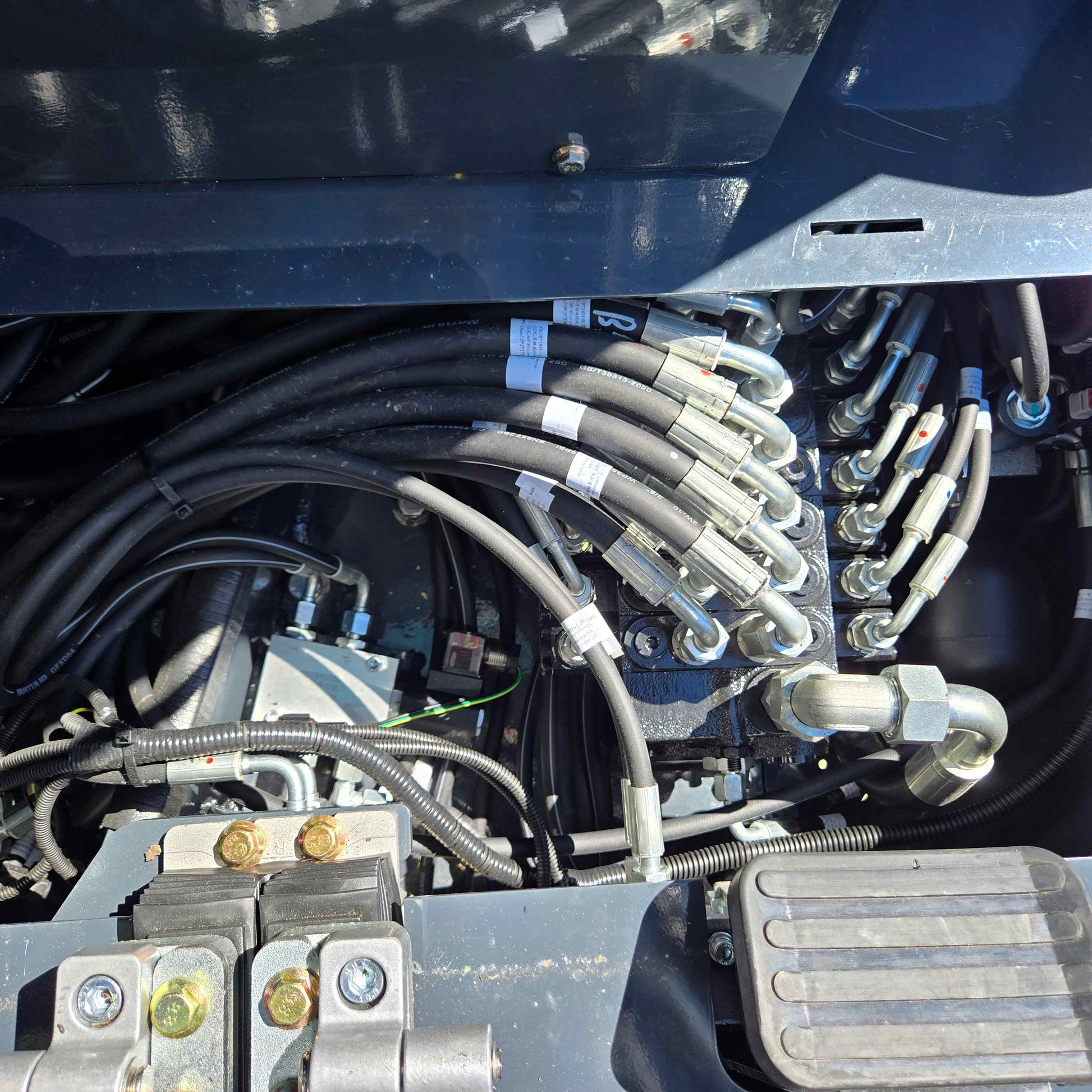 Close-up of hydraulic hose system in Rippa R22 mini excavator – compact 2 ton excavator for sale in Canada with Yanmar engine, highlighting durable valve fittings and efficient flow control.