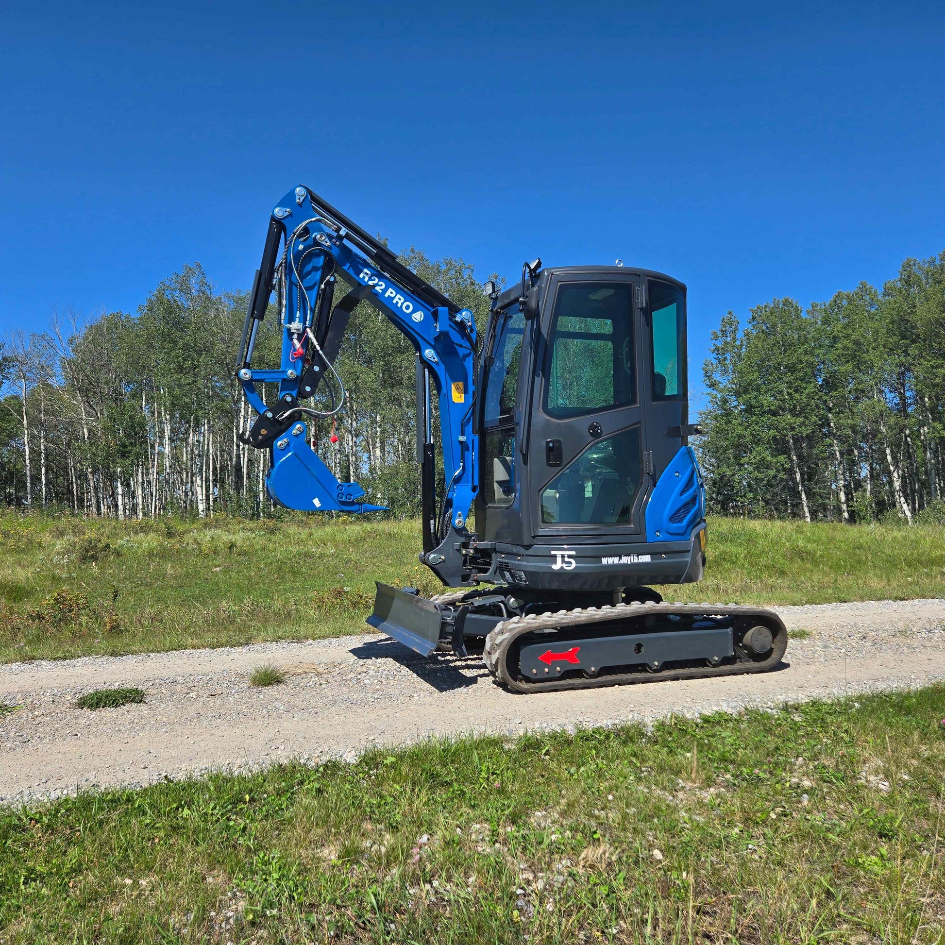 Rippa R22 Mini Excavator side view on gravel road compact 2 ton excavator with Yanmar engine for sale in Canada for construction and landscaping JoyT5