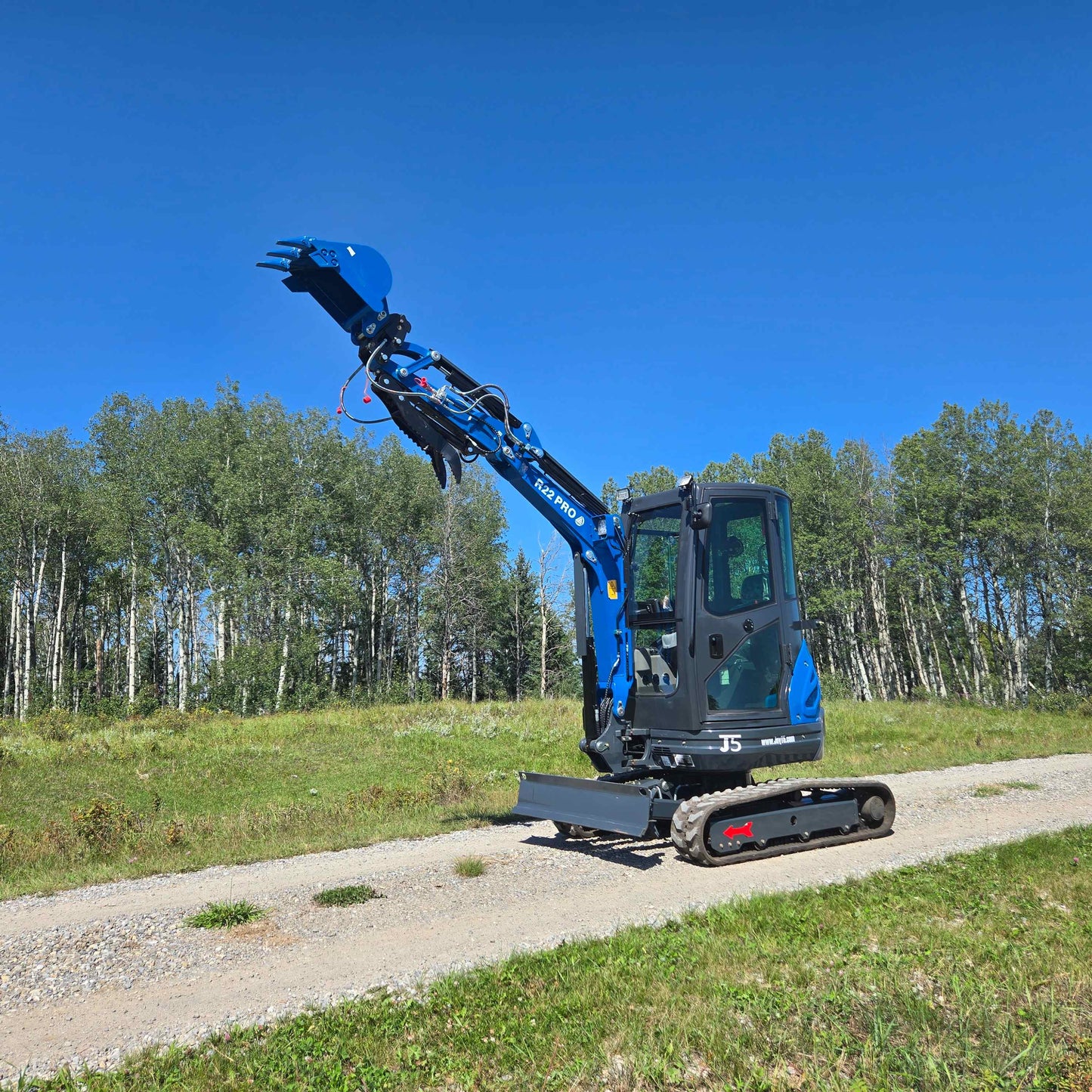 Rippa R22 Mini Excavator for sale with extended arm and bucket – Compact excavator on gravel road.