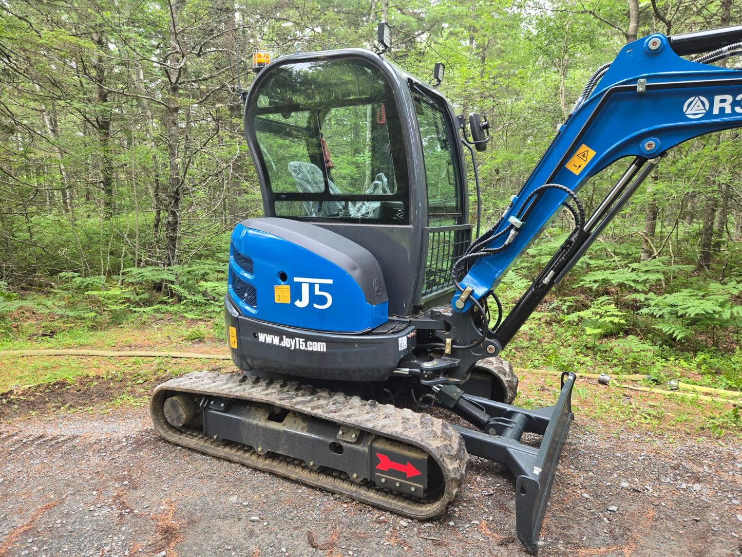 Close side view of Rippa R32 Mini Excavator with hydraulic system and durable tracks in Canada | JoyT5