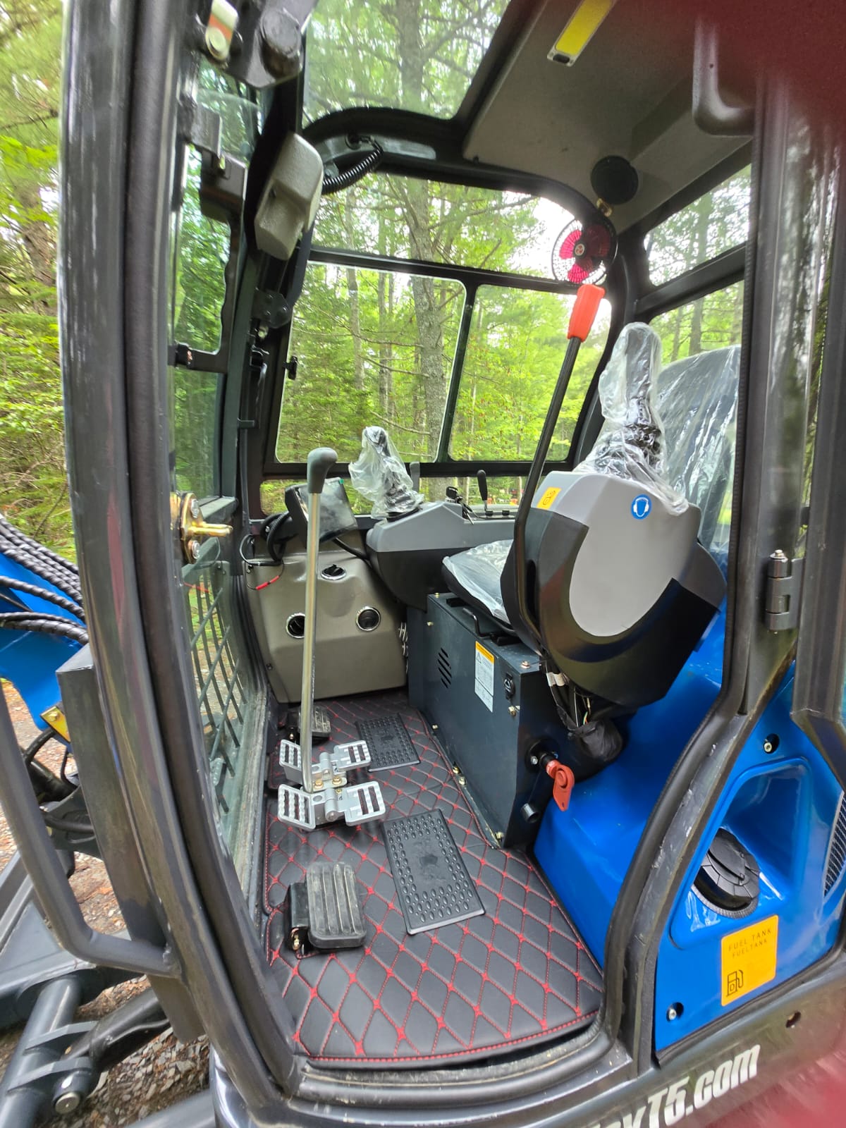 Interior cab view of Rippa R32 PRO Mini Excavator showing operator seat, pedals, and control levers – JoyT5 Canada | JoyT5