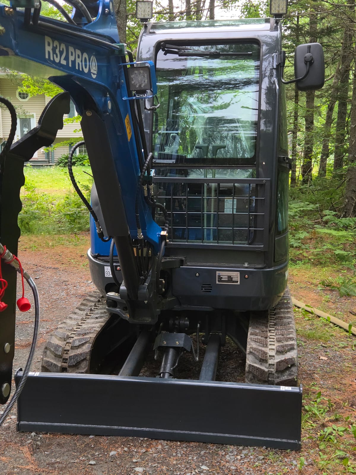 Rear view of Rippa R32 PRO Mini Excavator with protective cab and front blade – compact excavator Canada | JoyT5