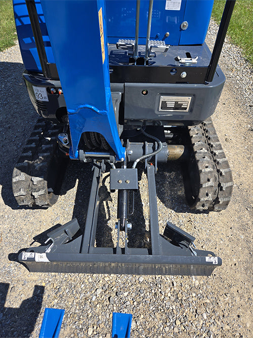 Close-up view of rippa r15 mini excavator for sale blade and track system on gravel surface