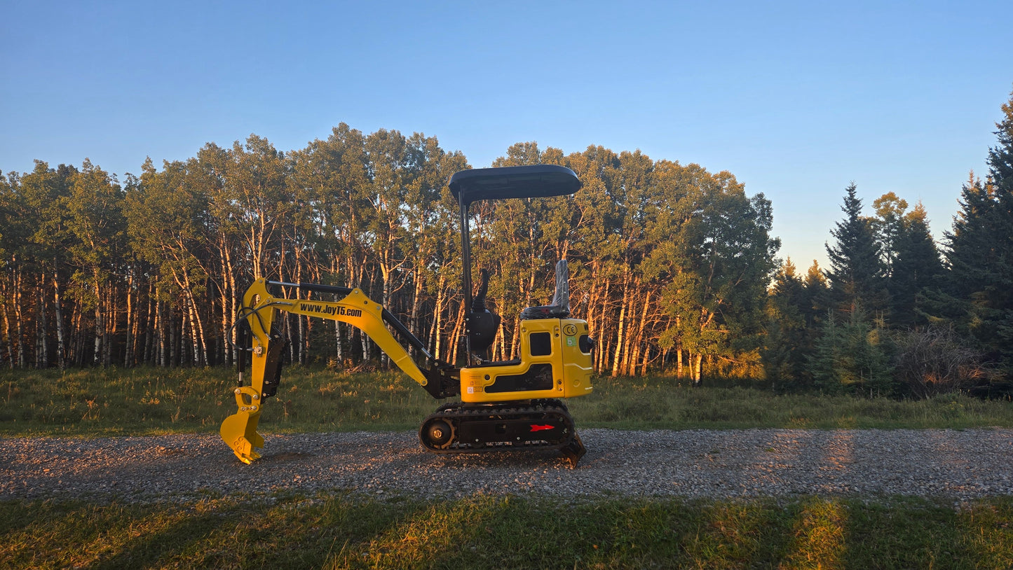 YardHoe YH12 compact yard excavator parked on gravel in front of trees in Canada small digging machine for landscaping and farm work with JoyT5 parts support