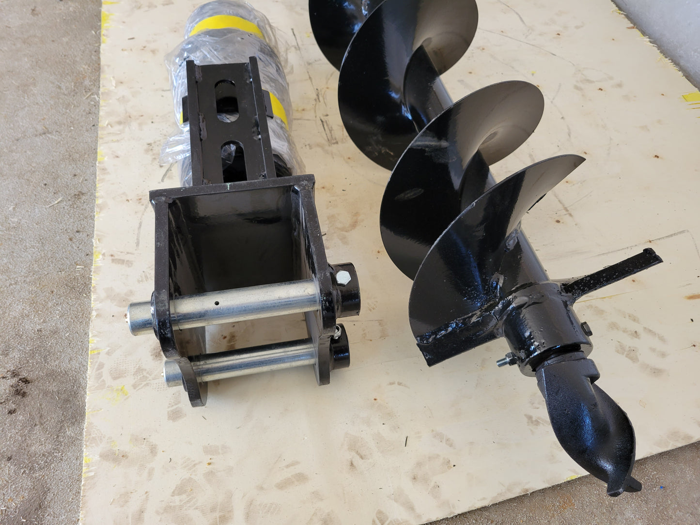 Close-up view of hydraulic auger attachment for excavators by JoyT5, a heavy-duty drilling tool.